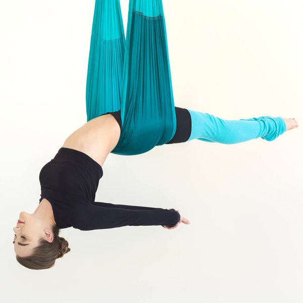 woman-practicing-fly-yoga-over-white-background-2L87HA3.jpg